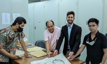 A photograph of the team with a diagram of a Rafflesia bud